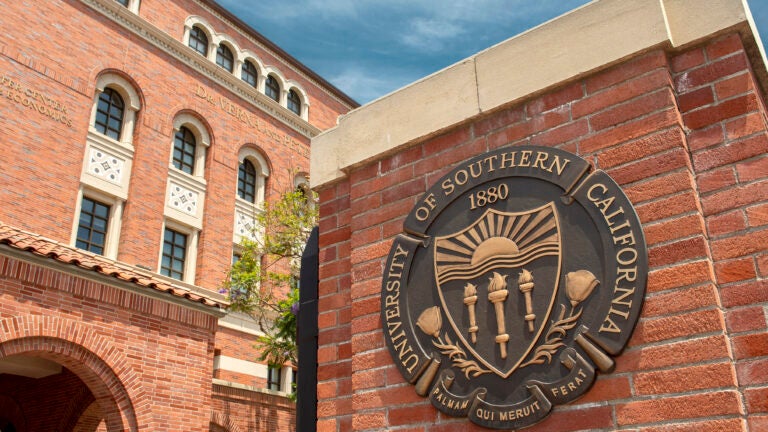 Seal of USC on a brick facade