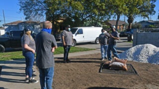 Men and women working outside.