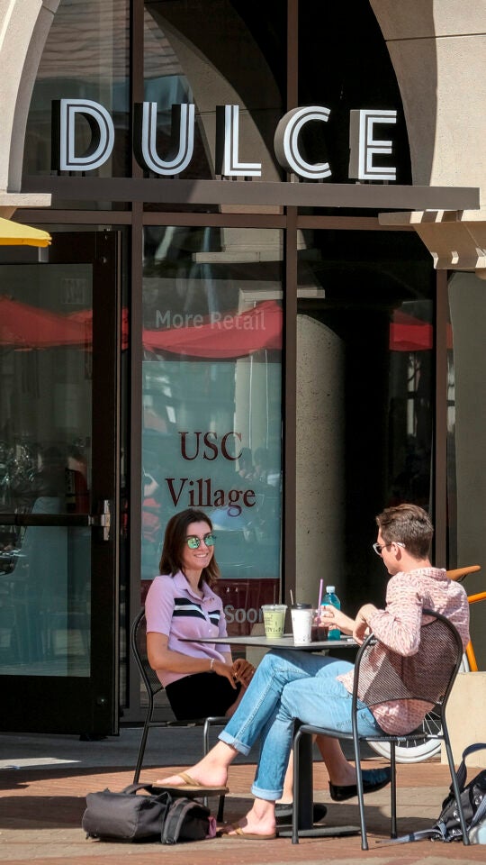 Students drinking coffee at Dulce Cafe at USC Village