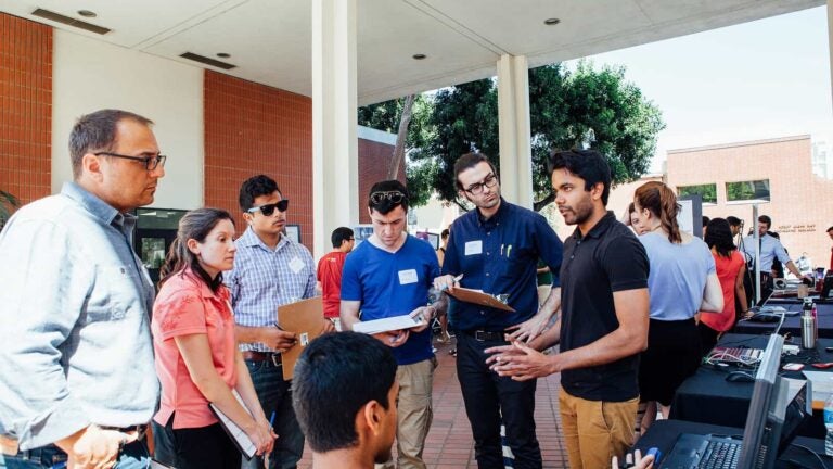 USC Viterbi School of Engineering students gather outside of a building during the school's undergraduate research symposium.