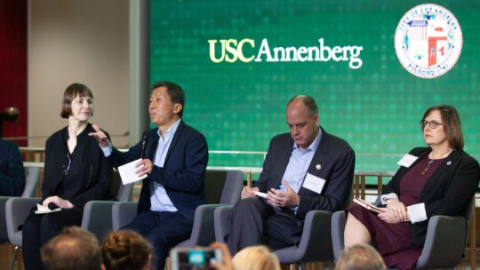 A panel of four sits on stage during the CPD Summit on City Diplomacy