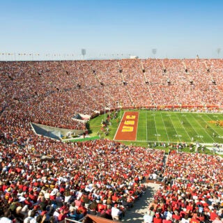 USC's Trojan Football team fans fill the Los Angeles Memorial Coliseum to capacity to watch the USC Trojans challenge its opponent.