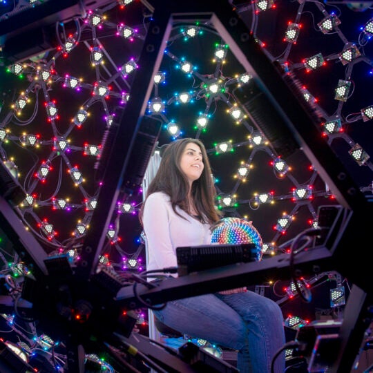 A female student inside a light stage at USC ICT.