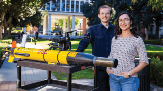 USC Viterbi students in front of a robot that fights against toxic algae