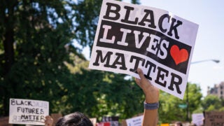 Woman holding up a Black Lives Matter sign