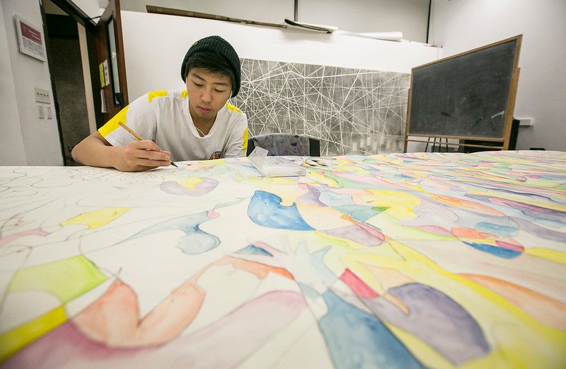 Roski student working on an art piece he created