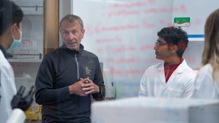 Peter Kuhn teaching students in a lab