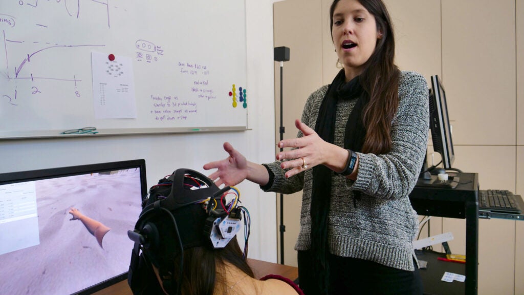 OT Professor working with a patient in front of a computer screen