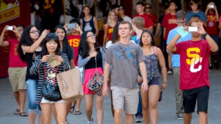 USC students walk through the coliseum tunnel to attend a Welcome Experience Rally