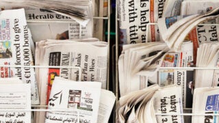 Close up of newspapers on a news stand