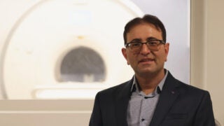 Professor Mahdi in front of projection