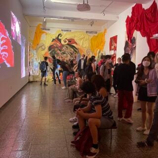 Students viewing an exhibit at a USC Roski gallery