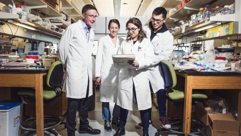 A USC professor with three students in a lab