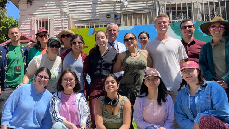 USC students and faculty pose for a group photo