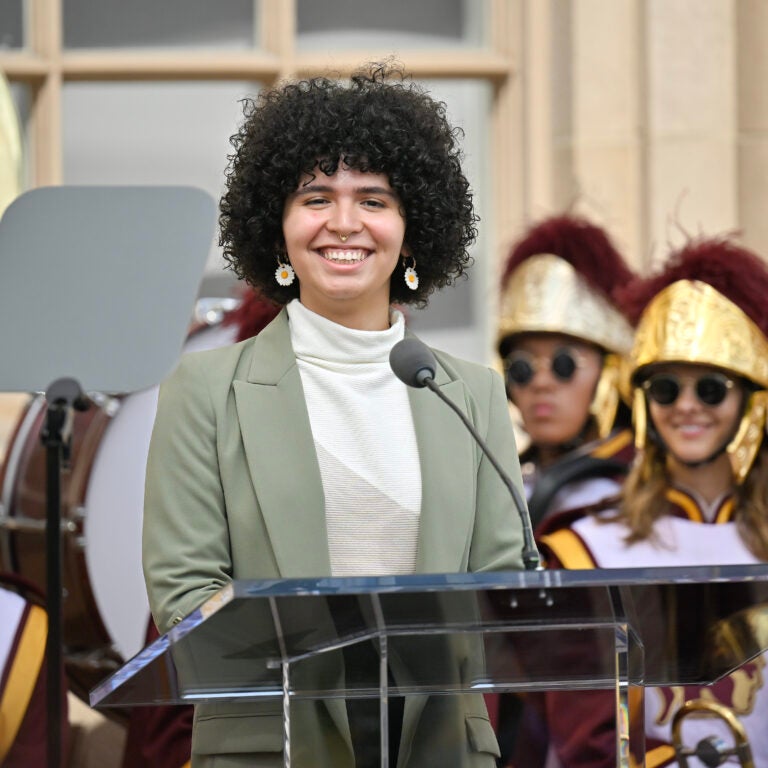 A student speaking at a podium