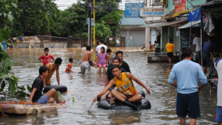 People using rafts in flood water