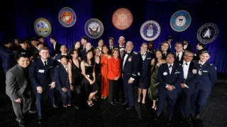 USC President Carol Folt poses with attendees at the university’s 16th annual gala for veterans, servicemembers and ROTC students. (USC Photo/Steve Cohn)