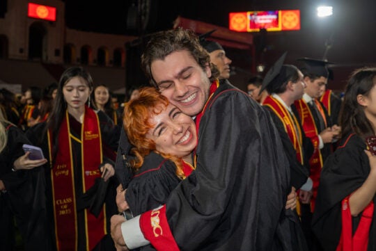 USC graduates hug in joy