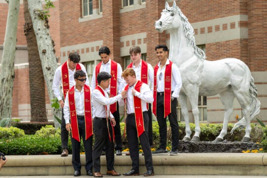 USC French study students pose for photograph in preparation for their graduation