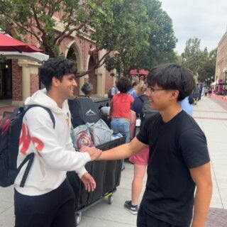Roommates Akshay Vadlamani, left, and Aiden Park meet face-to-face for the first time outside McCarthy Honors Residential College. (USC Photo/Greg Hernandez)