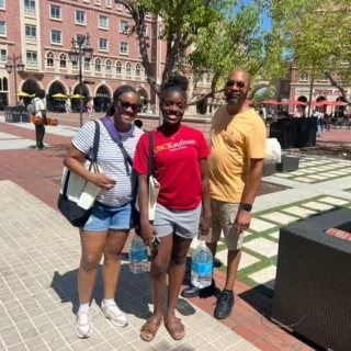 From South Carolina to Southern California, USC Kaufman freshman Kayla Uwagbai and her parents take a breather during move-in. (USC Photo/Greg Hernandez)