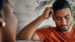 Man talking with woman on a couch