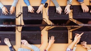 Top view of female students programming together