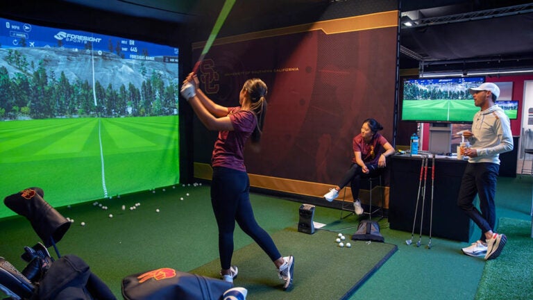 Golfer uses simulator